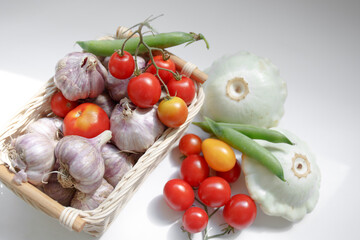 Homemade vegetables -green peas in pods, garlic, cherry tomatoes, squash. Nature. Composition with assorted raw organic vegetables. Detox diet. Fresh organic vegetables in the box. Organic harvest