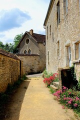 Beautiful European village of Vezelay in France, Burgundy. A narrow ancient French street of a medieval town with old buildings and houses and stone walls, a popular travel destination.