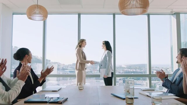 business women shaking hands in boardroom meeting successful corporate partnership deal with handshake colleagues clapping hands welcoming opportunity for cooperation in office 4k