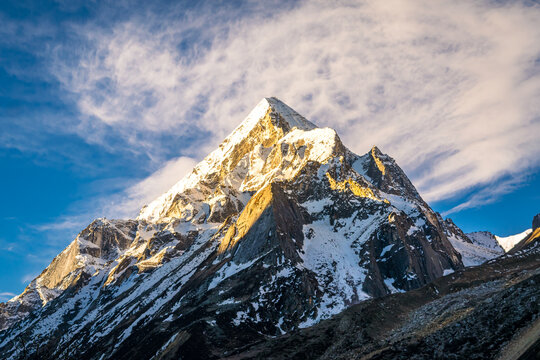 Sunrays falling on peaks of Mount Bhrigupanth during sunrise from Bhojbasa. Bhrigupanth with an elevation of 6772m  is a mountain in the Gangotri Group of the Garhwal Himalayas at Uttarakhand, India.