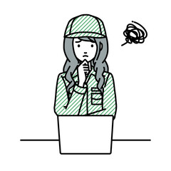 デスクで座ってPCを開いて困っている作業員の女性
