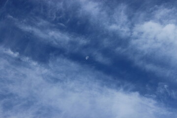 Obraz premium Moon between white clouds. Russia.