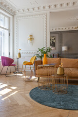 luxury interior of a spacious apartment in an old 19th century historical house with modern furniture. high ceiling and walls are decorated with stucco