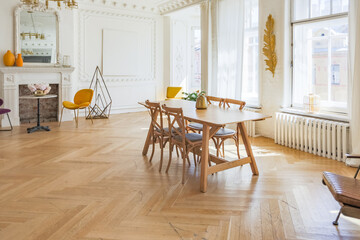 luxury interior of a spacious apartment in an old 19th century historical house with modern furniture. high ceiling and walls are decorated with stucco
