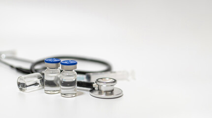 Fototapeta na wymiar copy space. coronavirus vaccine bottle, stethoscope and medical equipment on white background, virus prevention, vaccination, medical technology, research laboratory, covid-19 vaccine concept