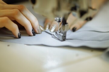 sewing machine scribbling fabric. tailoring at the factory