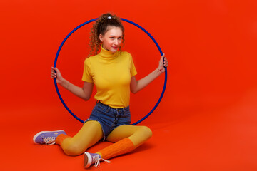 Shot of pretty fitness girl holding hula hoop © lotosfoto