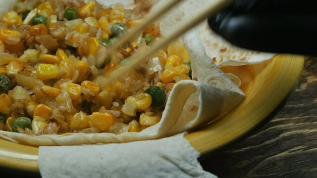 Stir fried vegetables on delicious pita bread in a yellow ceramic bowl with hasi chopsticks. rotate slowly. National Asian food