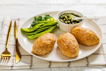 Baked white fish cakes with avocado and sauce
