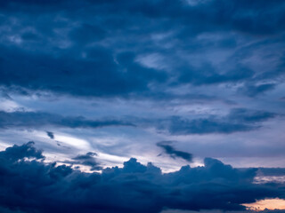 Naklejka premium A panorama of the evening sky with dark blue clouds of various shades.