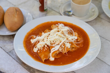 Red Enchiladas - traditional mexican food with tomato sauce and cheese in Mexico