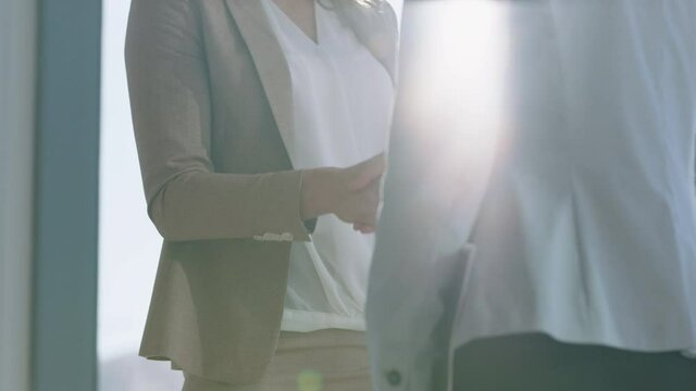 close up business women shaking hands in boardroom successful corporate partnership deal welcoming opportunity for cooperation in office workplace 4k