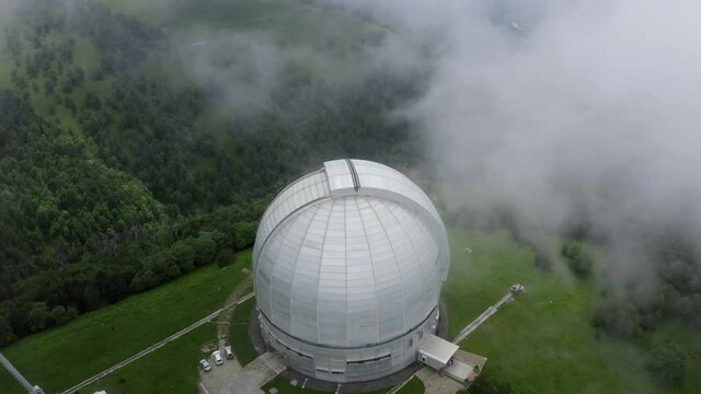 Nizhny Arkhyz, Russia - June 26, 2021: Aerial view of Astrophysical observatory of Russian Academy of Sciences in Caucasus. Static camera above BTA tower. Scenic landscape, cosmos, astronomy concept