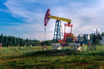 oil pumping stations in a clearing in the forest