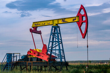 pumpjack operating at an oil well in field outdoors
