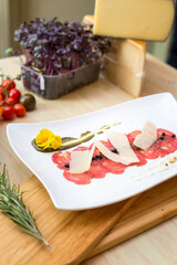 carpaccio appetizer on wooden table with vegetables