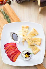 Salomon with focaccia on wooden board in restaurant
