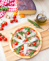 pizza focaccia with tomatoes, cheese and rucola