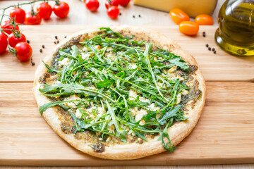 Focaccia with  rucola  and cheese on wooden board