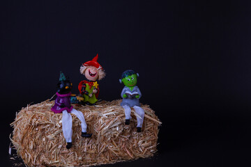Halloween Characters Sitting on a Haystack - Fun Times