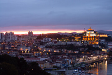 Fototapeta na wymiar Panoramic view on Douro river and old part of Porto city in Portugal at cloudy sunset