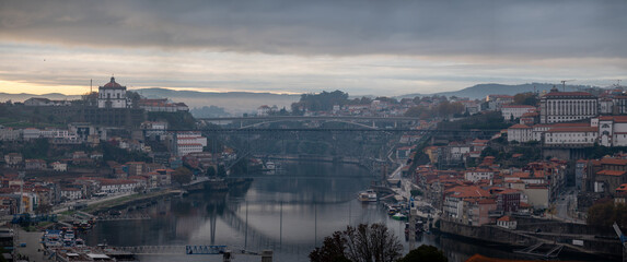 Panoramic view on Douro river and old part of Porto city in Portugal at cloudy sunrise