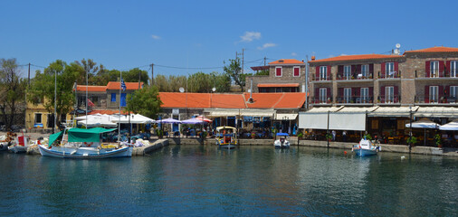 Obraz premium Pretty harbour at Molyvos on the island of Lesvos with fishing boats and restaurants. 