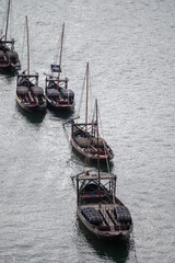 Obraz premium Old traditional wooden boat using for transportation wine barrels in Douro river valley, wine and port making industry in Portugal