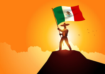 Mexican man in sombrero and traditional costume holding the flag of Mexico on mountain peak