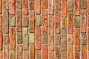 Brickwork in a variety of reddish hues, applied in a vertical bond