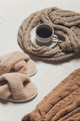 Fototapeta na wymiar a sweater, coffee and a candle on a white background . winter cozy image