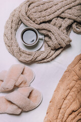 a sweater, coffee and a candle on a white background . winter cozy image