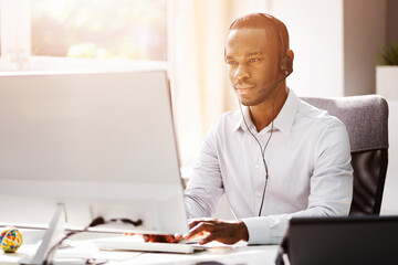 Business Service Agent With Headset At Computer