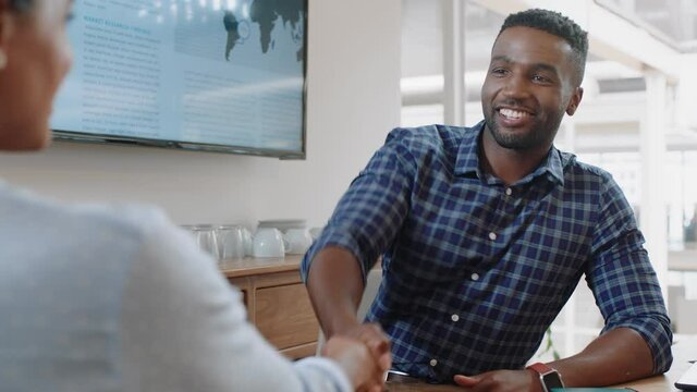 successful job interview african american businessman shaking hands with intern in meeting congratulations for new career opportunity in corporate office