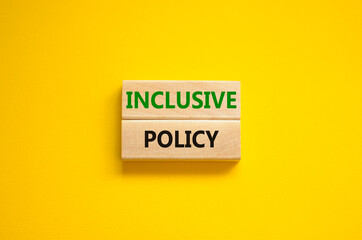 Inclusive policy symbol. Wooden blocks with words Inclusive policy on beautiful yellow background. Business, HR and inclusive policy concept. Copy space.