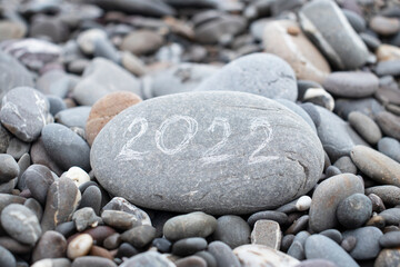 stone with 2022 inscription by the sea