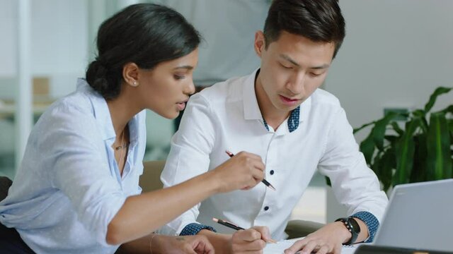 beautiful business woman team leader training asian intern using laptop computer sharing ideas colleagues working together in office