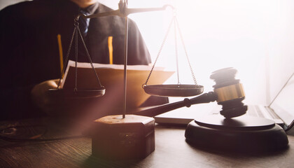 justice and law concept.Male judge in a courtroom on wooden table and Counselor or Male lawyer...