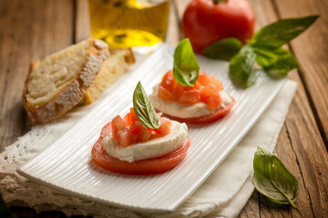 Caprese salad traditional italian recipe with mozzarella tomato basil and bread
