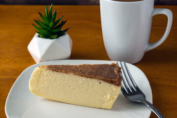 slice of cheese cake with a cup of coffee