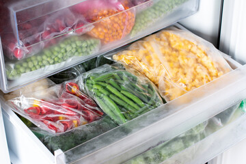 Frozen food in the freezer. Frozen vegetables, ready meals in the freezer. Frozen meat, food and vegetables.