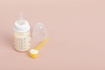 Preparation of formula for baby feeding. Baby health care, organic mixture of dry milk concept.