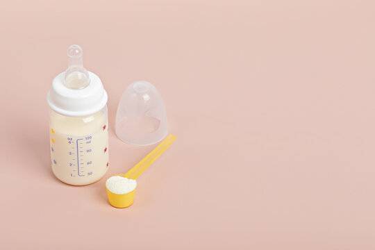 Preparation of formula for baby feeding. Baby health care, organic mixture of dry milk concept.
