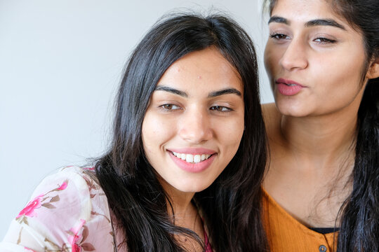 Two young beautiful Indian girls taking a selfie