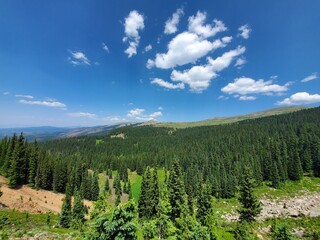 Mountains, forests and valleys of Indian Peaks Wilderness in Arapaho National Forest, Colorado on clear sunny summer afternoon.