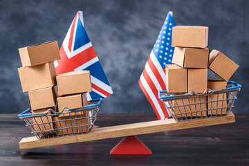 Filled shopping basket and cart with US and United Kingdom flags on seesaw. Trade balance concept