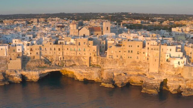 Aerial view at dawn of Pomigliano by the sea in Bari in Puglia. Rocks on the sea with the sun and a beautiful landscape