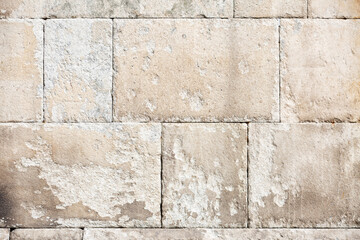muro de piedra con textura de  muralla antigua medieval desgastada, con colores cálidos close-up