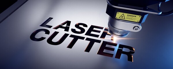Laser cutter close up, cutting word 
