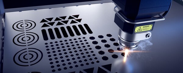 Laser cutter close up, cutting geometric patterns in a metal sheet. 